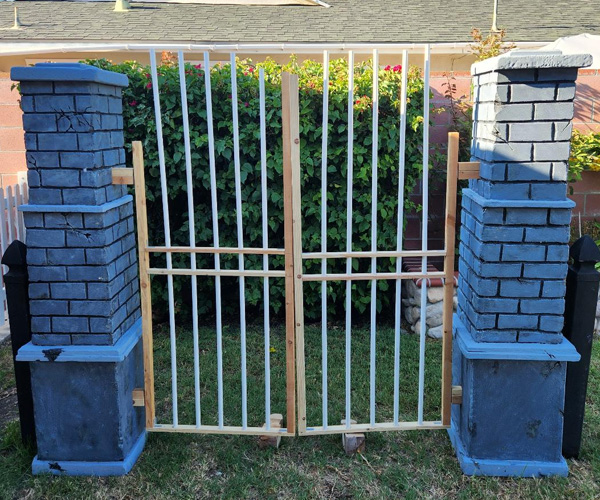 Cemetery gate is looking good with those vertical PVC poles.